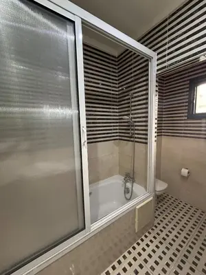 a bathroom with a shower and a bath tub at Villa in marrakech city center with heated pool and breakfast inclued in Marrakech