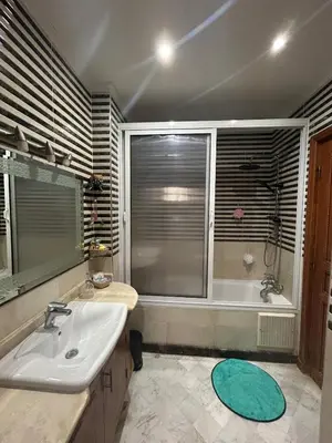 a bathroom with a sink and a tub and a window at Villa in marrakech city center with heated pool and breakfast inclued in Marrakech