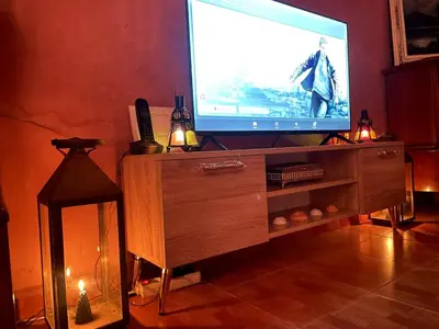 a tv on a wooden entertainment center with a television screen at Riad Red Diamond in Marrakech