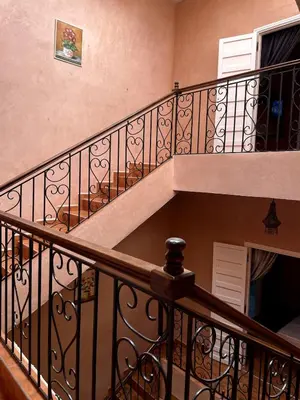 an empty stairway with a wooden railing at Riad Red Diamond in Marrakech