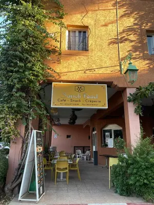 a restaurant with tables and chairs in front of a building at Riad Red Diamond in Marrakech