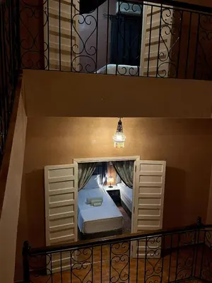 a room with a bed in the middle of a staircase at Riad Red Diamond in Marrakech