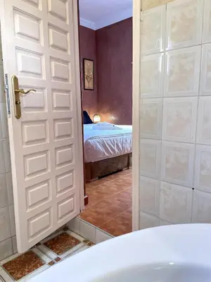 a bathroom with a door leading to a bedroom at Riad Red Diamond in Marrakech