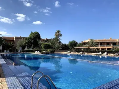 a large swimming pool with blue water in a resort at Prestigious residence with pools and gardens in Marrakech