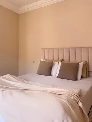 a bedroom with a large bed with white sheets and pillows at Stunning 2BR in Top Location Marrakech City Center in Marrakech