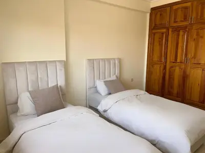 two beds sitting next to each other in a room at Stunning 2BR in Top Location Marrakech City Center in Marrakech