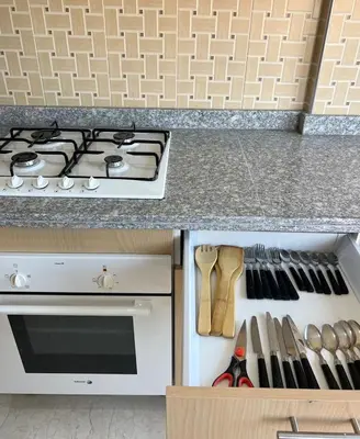 a kitchen with a stove and a drawer with utensils at Stunning 2BR in Top Location Marrakech City Center in Marrakech