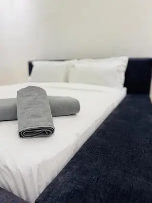 a white bed with two towels on top of it at Chez Yous in Marrakech