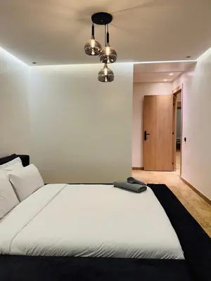 a bedroom with a large white bed with a ceiling at Chez Yous in Marrakech