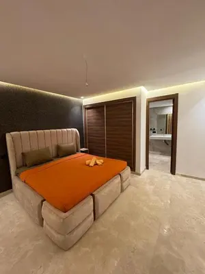 a bedroom with a large bed with an orange blanket at for you - perfect place in Marrakech