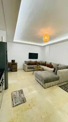 a living room with two couches and a tv at Cozy luxury apartment downtown pool wifi fiber parking in Marrakech