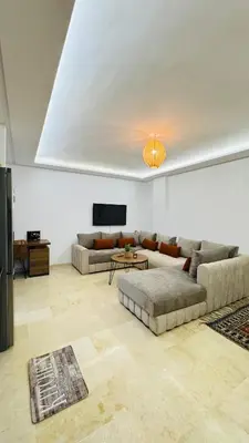 a living room with two couches and a tv at Cozy luxury apartment downtown pool wifi fiber parking in Marrakech