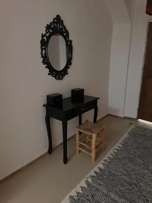 a black desk with a mirror and a stool at Villa Léa in Marrakech