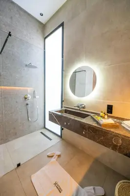 a bathroom with a shower and a sink and a mirror at Berber Garden in Aït Amara