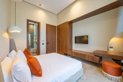 a bedroom with a bed and a tv on the wall at Berber Garden in Aït Amara