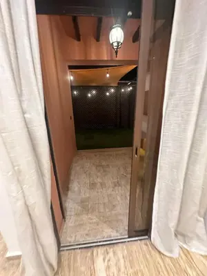 a mirror reflection of a hallway with a door with curtains at City garden in Marrakech
