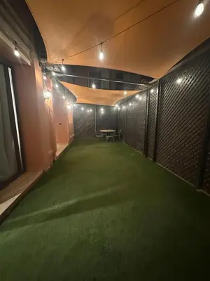a room with a green carpet in a room with a table at City garden in Marrakech