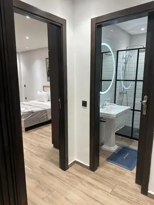 a bedroom with a bed and a sink and a mirror at City garden in Marrakech