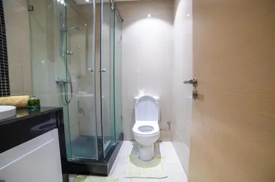 a bathroom with a toilet and a glass shower at Prestigia golf city marrakech in Marrakech