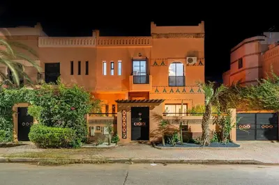 a building in the middle of a street at night at Luxury Beldi & Piscine at Villa Riad El Menzeh in Marrakech