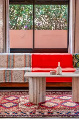 a room with a red bench and a window at Luxury Beldi & Piscine at Villa Riad El Menzeh in Marrakech