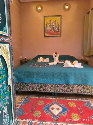a bedroom with a bed with two swans on it at Riad DAR BARBI in Marrakech