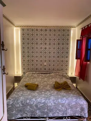 a bedroom with a bed with two towels on it at Riad DAR BARBI in Marrakech
