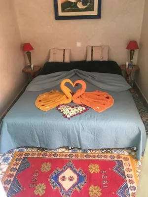 a bed with two towels on top of it at Riad DAR BARBI in Marrakech