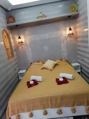 a bedroom with a bed with two stuffed animals on it at Riad DAR BARBI in Marrakech