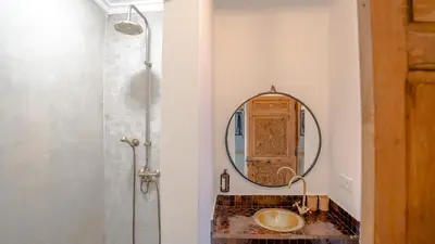 a bathroom with a sink and a mirror at Manzil Fanny Private Riad & Spa in Marrakech