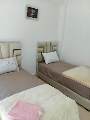 two beds sitting next to each other in a room at Appartement Lady Plaza 1 in Marrakech