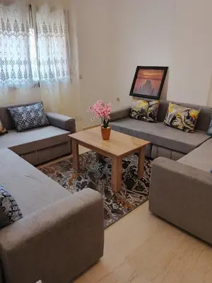 a living room with couches and a coffee table at Appartement Lady Plaza 1 in Marrakech