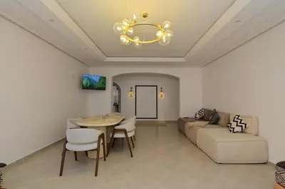 a living room with a table and a couch at Appartement spacieux de 3 chambres à gueliz in Marrakech