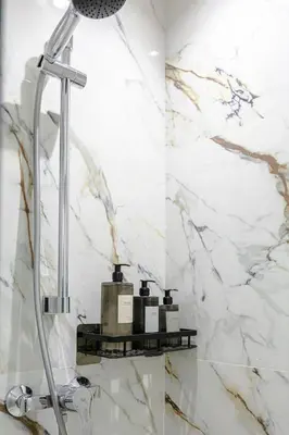 a shower with three bottles on a shelf in a bathroom at 5-Star Duplex - Private Pool in Marrakech