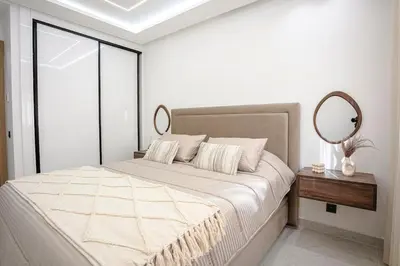 a bedroom with a large bed with a mirror at 5-Star Duplex - Private Pool in Marrakech