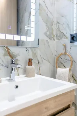 a bathroom with a white sink and a mirror at 5-Star Duplex - Private Pool in Marrakech