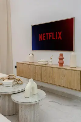 a television on a wall in a room with a table at 5-Star Duplex - Private Pool in Marrakech