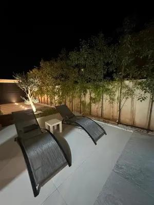 two black chairs sitting on a patio at night at Luxury Villa Marrakech in Marrakech