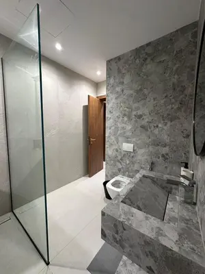 a bathroom with a glass shower and a toilet at Luxury Villa Marrakech in Marrakech