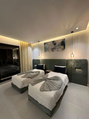 a hotel room with two beds and a couch at Luxury Villa Marrakech in Marrakech