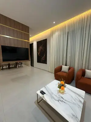 a living room with a large television and a couch and chairs at Luxury Villa Marrakech in Marrakech