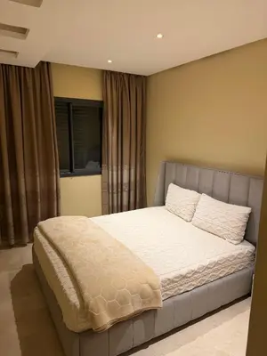 a bedroom with a large bed with white sheets at Etoile De Marrakech in Marrakech
