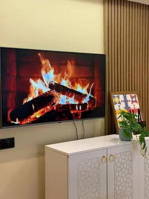a fireplace with three fires in a living room at Etoile De Marrakech in Marrakech