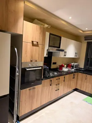 a kitchen with wooden cabinets and a stove top oven at Etoile De Marrakech in Marrakech