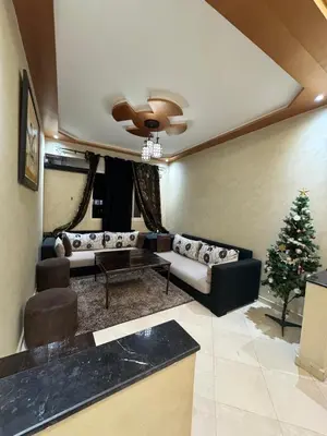 a living room with a couch and a christmas tree at 2 bedroom apartment in a perfect location in Marrakech