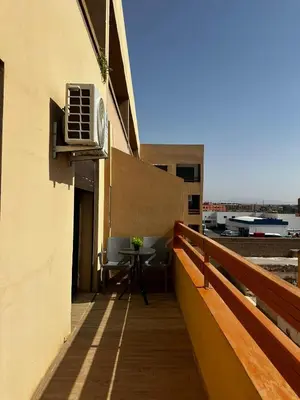 a balcony with a table and an air conditioner on a building at Hivernage & Gueliz Luxury Apt Pool near medina in Marrakech