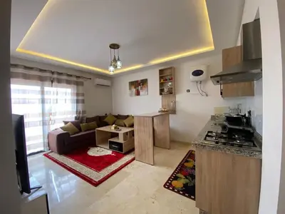 a living room with a couch and a kitchen at Hivernage & Gueliz Luxury Apt Pool near medina in Marrakech