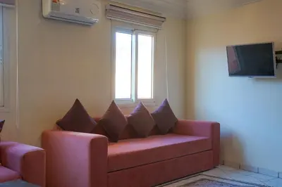 a living room with a couch and a window at appartement en résidence in Marrakech