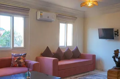 a living room with a couch and a tv at appartement en résidence in Marrakech