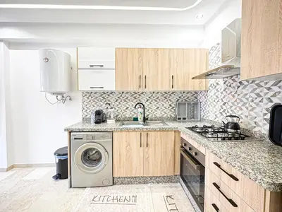 a kitchen with a sink and a washing machine at Oasis Gueliz - Piscine & parking privé in Marrakech